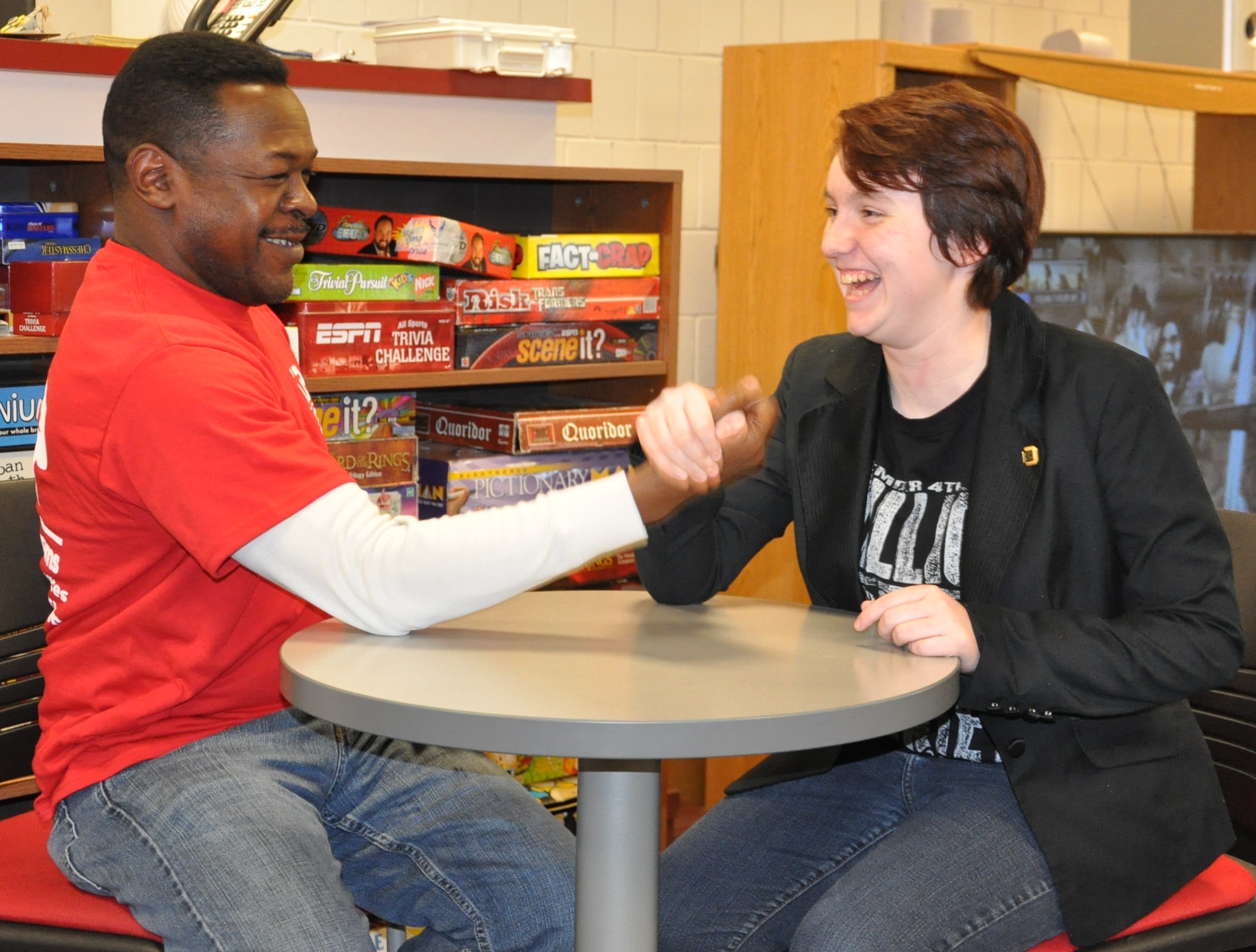 Rowan Goble (right) the Wright-Patterson Air Force Base Candidate for Youth of the Year, and Bennie Luck, the Youth Programs coordinator, arm wrestle at the Prairies Youth Center. (Air Force photo by Gina M. Giardina)