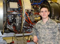Airman 1st Class Michael Gemma, 175th Maintenance Squadron aircraft engine mechanic, stands in front of a T-34 engine at Warfield Air National Guard Base in Baltimore, Md. Gemma is the 175th Wing April Airman Spotlight. (U.S. Air National Guard photo by Tech. Sgt. David Speicher/RELEASED)