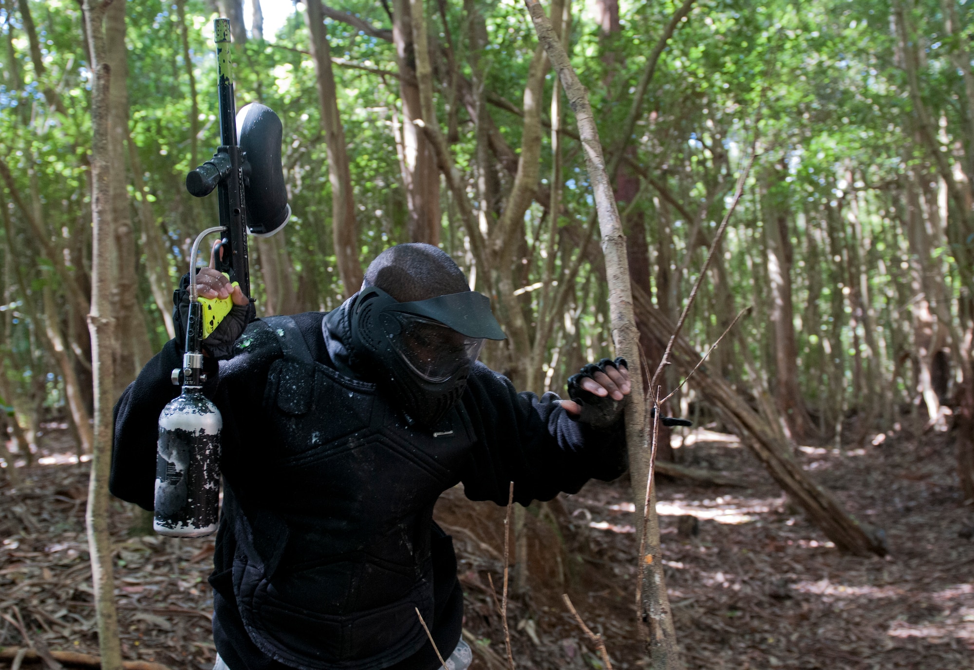 Master Sgt. Jerry Graham, 65th Communications Squadron quality assurance manager, stands up after being shot with a paintball during a men's paintball trip, April 4, 2015. The chapel hosted this event as a way for Airmen to have fun in a safe and clean environment and to increase resiliency in the physical, social and spiritual domains of the RUFit? model. (U.S. Air Force photo/Staff Sgt. Zachary Wolf)