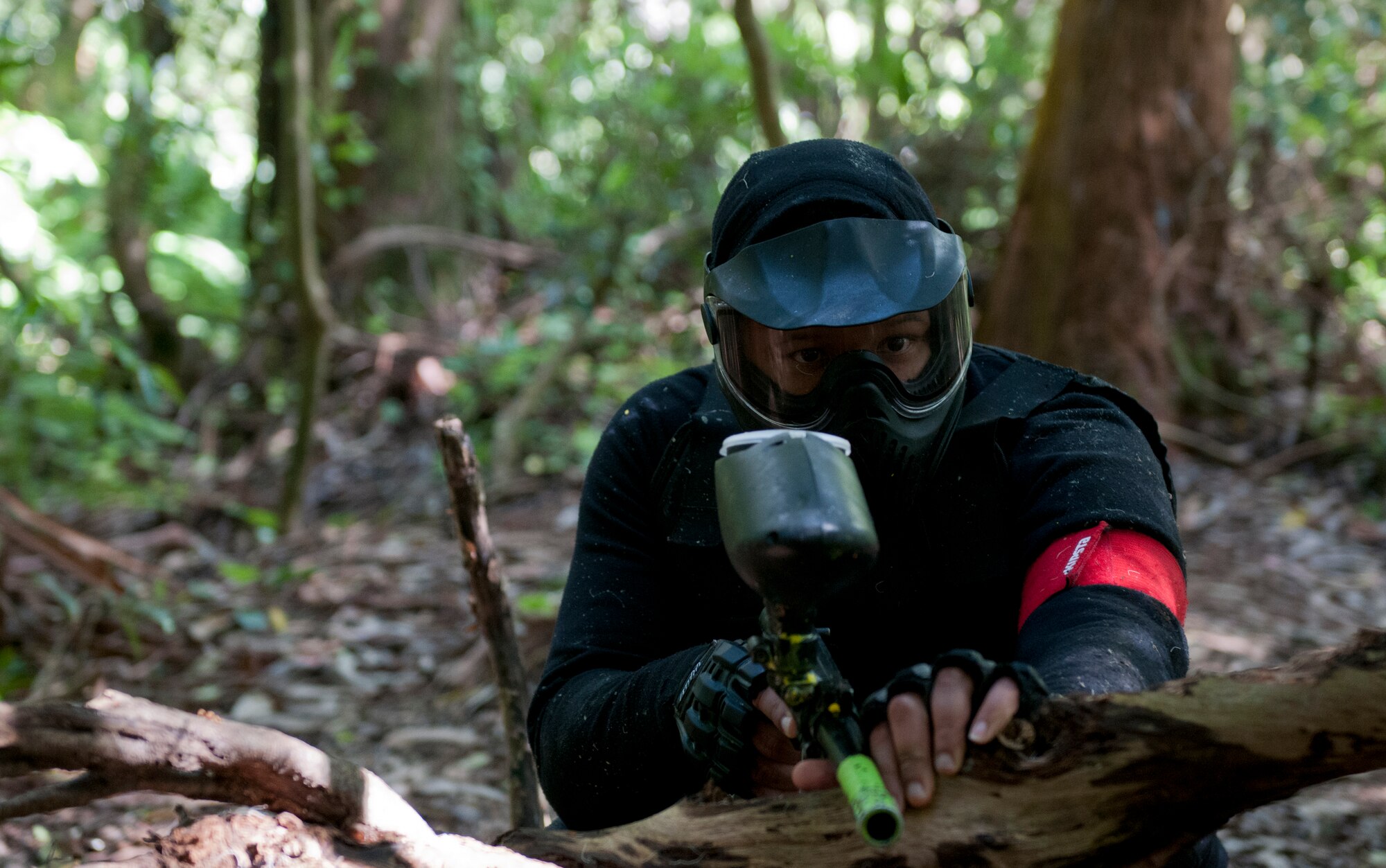 Master Sgt. Shawn Hamilton, 65th Communications Squadron plans and programs section chief, looks for members of the opposite team during a men's paintball trip, April 4, 2015. The chapel hosted this event as a way for Airmen to have fun in a safe and clean environment and to increase resiliency in the physical, social and spiritual domains of the RUFit? model. (U.S. Air Force photo/Staff Sgt. Zachary Wolf)