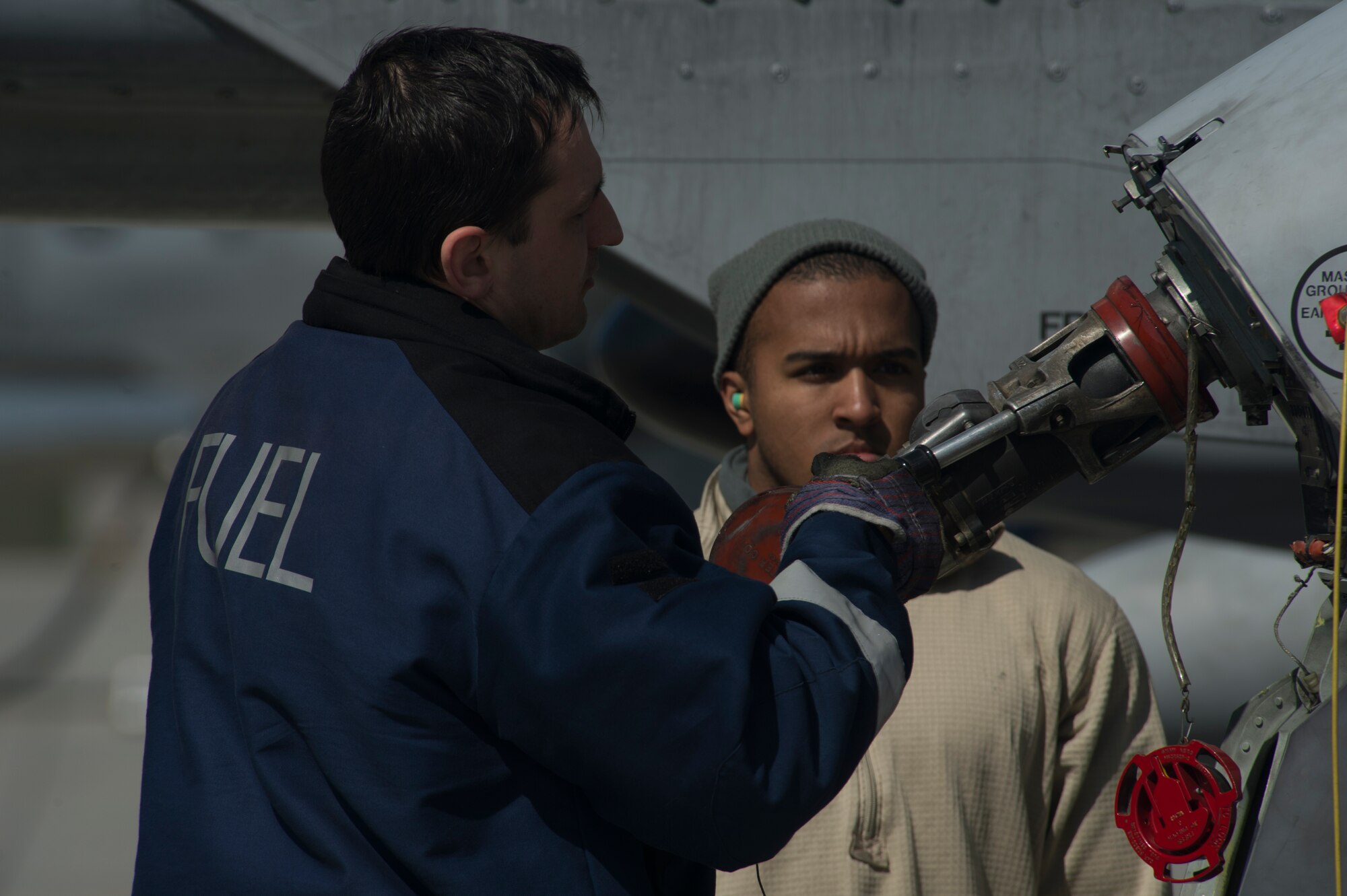 A 354th Expeditionary Fighter Squadron Airmen assists a Czech Republic air force member to refuel a U.S. Air Force A-10 Thunderbolt II attack aircraft during a theater security package deployment to Namest Air Base, Czech Republic, April 9, 2015. TSP deployments and combined training like this demonstrate the shared commitment in promoting a peaceful and stable Europe. (U.S. Air Force photo by Staff Sgt. Christopher Ruano/Released)
