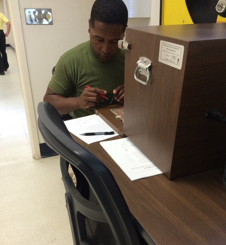 A Marine from BEEEST 5-15 conducts practical application on DC theory.
