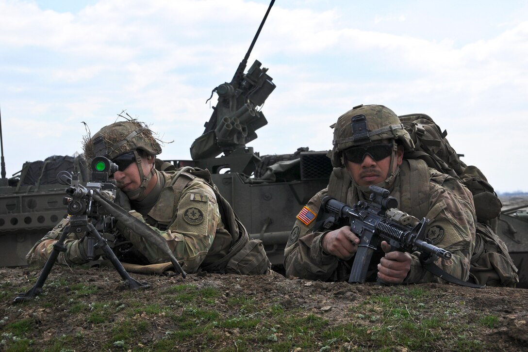 U.S. Army Pfc. Andrew Ochoa, left, and Army Spc. Nicholas Carrillo take ...