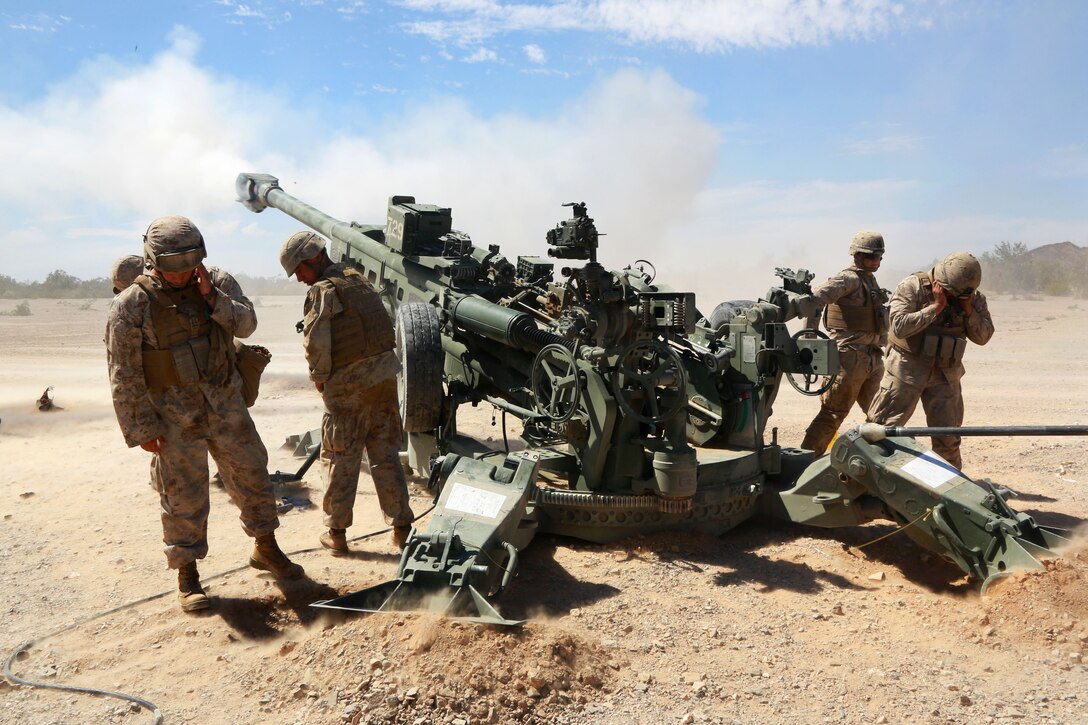 Marines fire 155mm rounds using an M777 Howitzer system during an artillery raid exercise as part of a weapons and tactics course for instructors on Marine Corps Air Station Yuma, Ariz., April 4, 2015. The Marines are artillerymen assigned to 1st Battalion, 10th Marine Regiment.