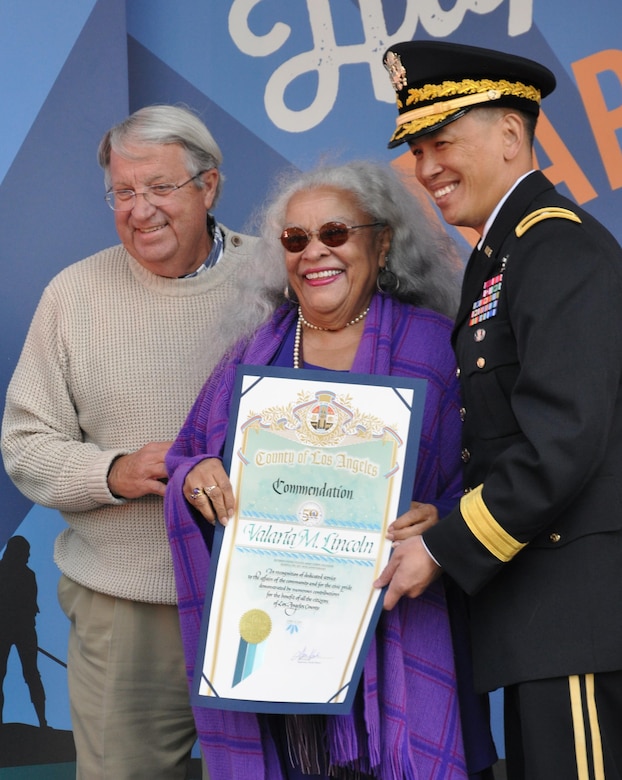 Brig. Gen. Mark Toy, commanding gGeneral of the USACE South Pacific Division and Don Knabe, Los Angeles County Supervisor, presented a scroll to Valeria Lincoln, a former USACE employee who worked on the marina since its beginning in the 1950s at a ceremony April 10. USACE workers were recognized at Marina del Rey's 50th Birthday Bash for the design and work efforts in taking and keeping the marina from the duck hunting marsh it was into the marina it is today.