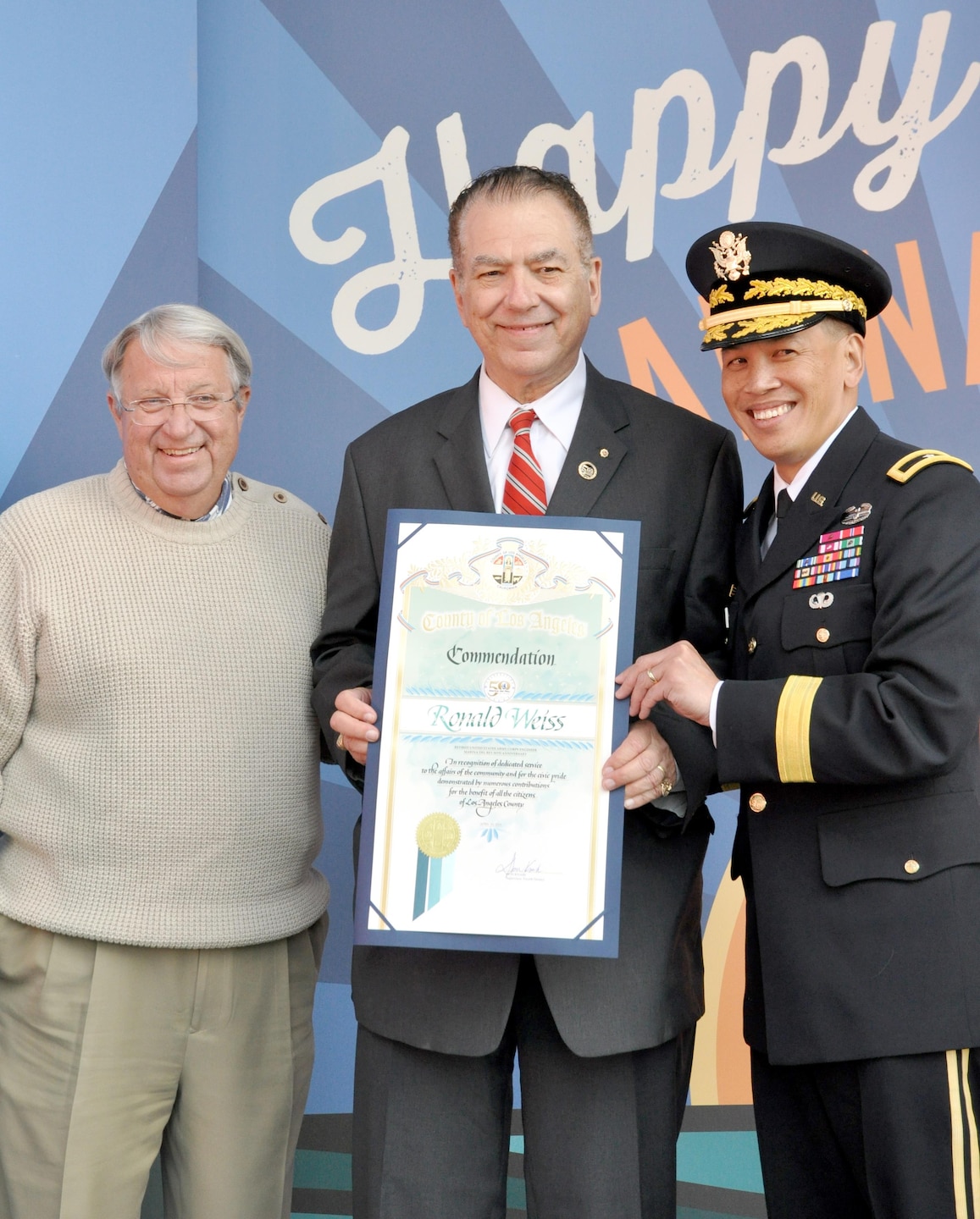 Brig. Gen. Mark Toy, commanding general of the USACE South Pacific Division and Don Knabe, Los Angeles County supervisor, presented a scroll to Ron Weiss, a former USACE employee who worked on the marina since its beginning in the 1950s at a ceremony April 10. USACE workers were recognized at Marina del Rey's 50th Birthday Bash for the design and work efforts in taking and keeping Marina del Rey from the duck hunting marsh it was into the marina it is today.