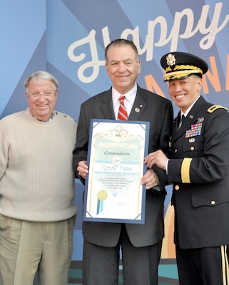 Brig. Gen. Mark Toy, commanding general of the USACE South Pacific Division and Don Knabe, Los Angeles County supervisor, presented a scroll to Ron Weiss, a former USACE employee who worked on the marina since its beginning in the 1950s at a ceremony April 10. USACE workers were recognized at Marina del Rey's 50th Birthday Bash for the design and work efforts in taking and keeping Marina del Rey from the duck hunting marsh it was into the marina it is today.