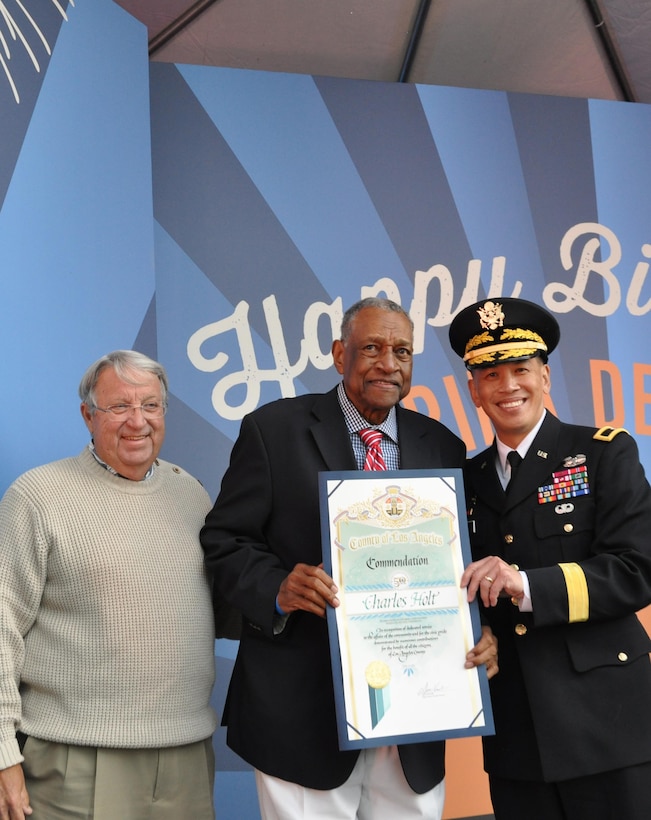 Brig. Gen. Mark Toy, commanding general of the USACE South Pacific Division and Don Knabe, Los Angeles County supervisor, presented a scroll to Charles 'Chuck' Holt, a former USACE employee who worked on the marina since its beginning in the 1950s at a ceremony April 10. USACE workers were recognized at Marina del Rey's 50th Birthday Bash for the design and work efforts in taking and keeping Marina del Rey from the duck hunting marsh it was into the marina it is today.