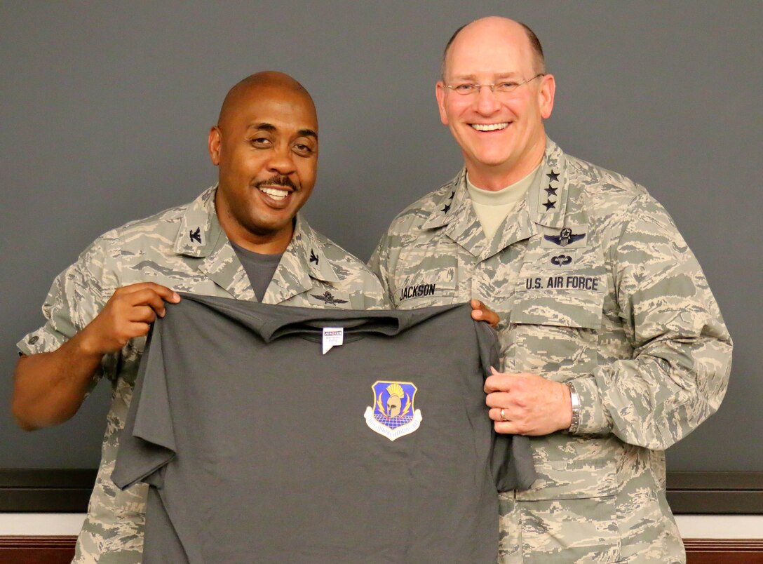 Col. Lloyd Terry, 960th Cyberspace Operations Group commander, presented Lieutenant General James F. Jackson, Air Force Reserve Command commander, a 960 CyOG unit morale t-shirt during his visit April 10 to the unit at Joint Base San Antonio-Lackland, Texas. The 960 CyOG is the first cyberspace group in the Air Force and has administrative control over 10 Reserve cyber units throughout the country. Its mission is to train and equip Citizen Airmen to extend, operate, defend and engage to fight and win... in, from and through Cyberspace. (U.S. Air Force photo/Master Sgt. Josh Woods)