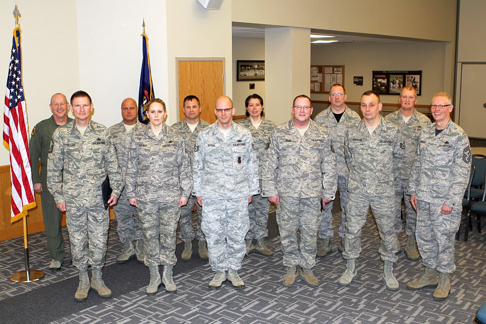 150411-Z-VA676-250 – A group of Michigan Air National Guard Airmen pose with Brig. Gen. John D. Slocum, 127th Wing commander, and Chief Master Sgt. Bob Dobson, 127th Wing command chief, following a re-enlistment ceremony at Selfridge Air National Guard Base, Mich., April 11, 2015. Thirty Michigan ANG Airmen re-enlisted for three years or more during the first quarter of fiscal year 2015. Several dozen more have extended their existing enlistment or re-enlisted for shorter periods. (U.S. Air National Guard photo by Tech. Sgt. Dan Heaton)