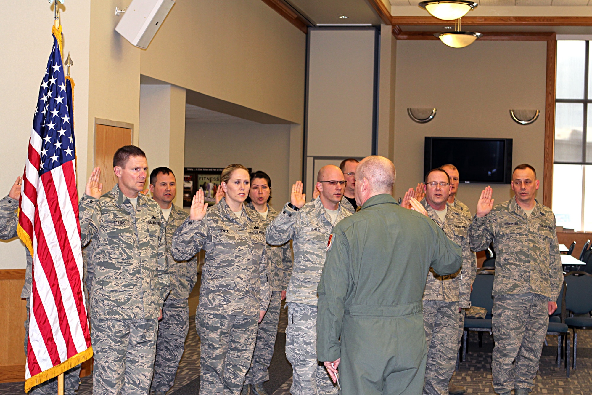 150411-Z-VA676-220 -- A group of Michigan Air National Guard Airmen take the oath of enlistment during a ceremony at Selfridge Air National Guard Base, Mich., April 11, 2015. Thirty Michigan ANG Airmen re-enlisted for three years or more during the first quarter of fiscal year 2015. Several dozen more have extended their existing enlistment or re-enlisted for shorter periods. Administering the oath is Brig. Gen. John D. Slocum, 127th Wing commander. (U.S. Air National Guard photo by Tech. Sgt. Dan Heaton)