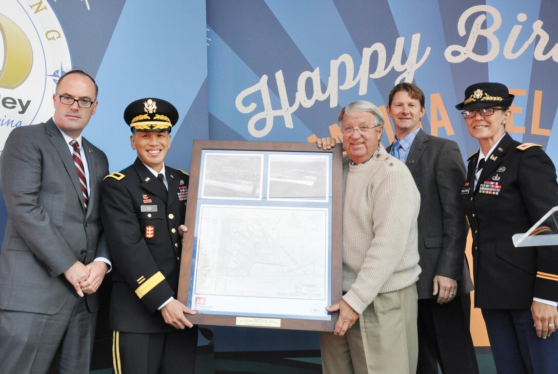 Brig. Gen. Mark Toy, commanding general of the USACE South Pacific Division, Col. Kim Colloton, Los Angeles District commander and David Van Dorpe, the District's deputy engineer for programs and project management, present a photo collage to Don Knabe, Los Angeles County supervisor, and Gary Jones, Director of Los Angeles County Department of Beaches and Harbors, for 50 years of partnership at a ceremony April 10.