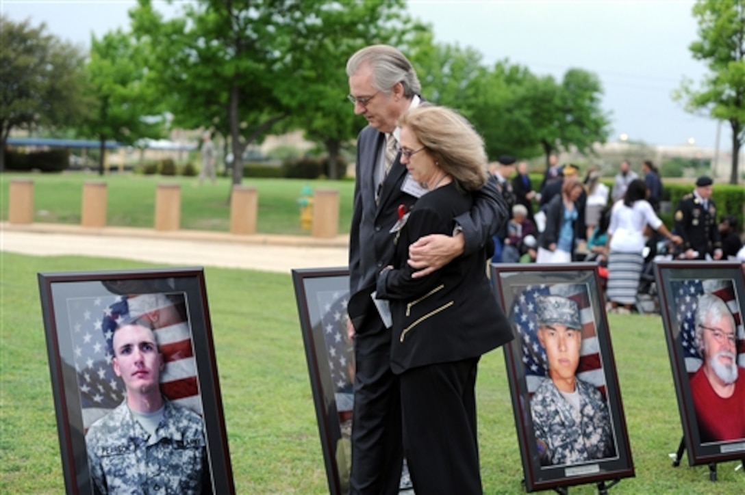 Jeffrey and Sheryll Pearson look at the portrait of their son, Army Pfc. Michael Pearson, before the Purple Heart and Defense of Freedom award ceremony on Fort Hood, Texas, April 10, 2015. The event honored the 13 people killed and more than 30 injured in a gunman’s 2009 shooting rampage on the base. 