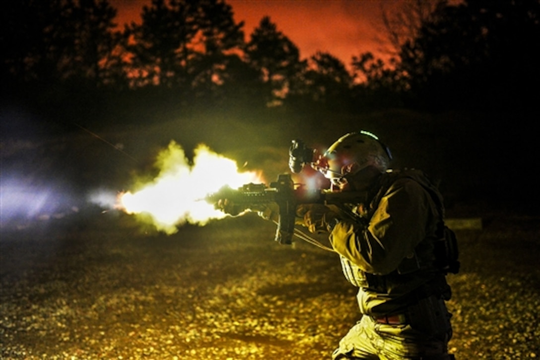 Air Force Tech. Sgt. Jason Cangemi test fires an M4 carbine during live-fire training at the firing range in Westhampton Beach, N.Y., April 9, 2015. Under real-world tactical conditions, a suppressor likely would mute the muzzle flash. Cangemi is assigned to the New York Air National Guard. The training included tactical movement, responding to incoming fire, retrieving and caring for wounded individuals, and night shooting. 