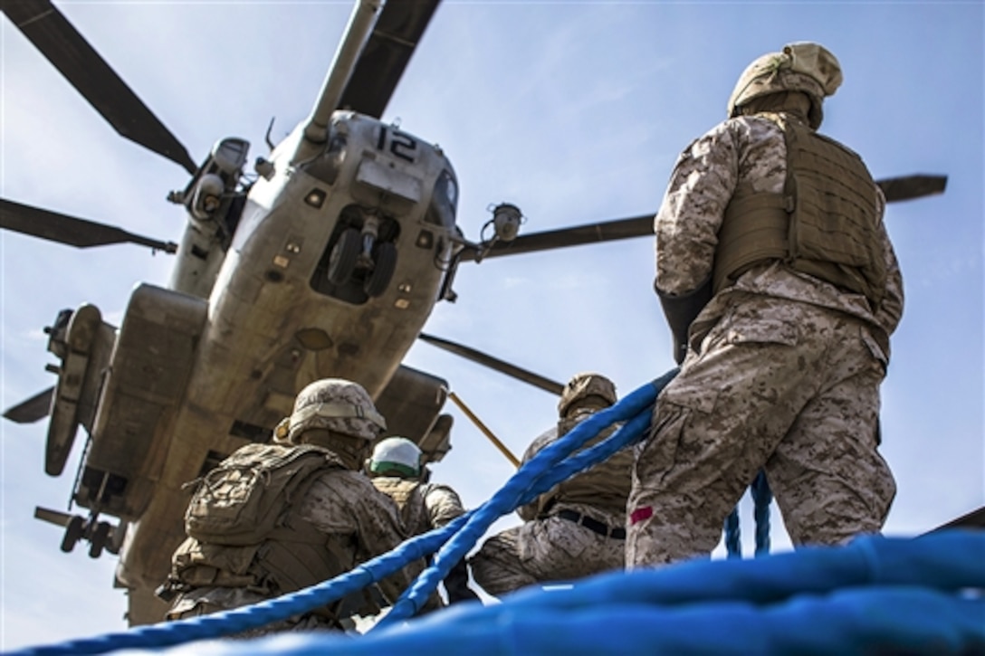 Marines conduct an external lift with a CH-53E Super Stallion helicopter during a weapons and tactics course for instructors near Yuma, Ariz., April 3, 2015. 