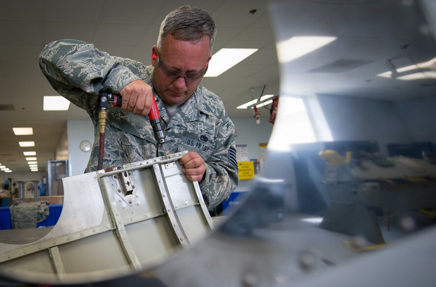 Tech. Sgt. Larry Howard, 919th Special Operations Maintenance Squadron fabrication flight, drills out the broken bolts to replace for an engine cover of a C-145 at Duke Field, Fla., April 19, 2015. A combination of a welding and machine shop, the metals technology section focuses on the repair and reproduction of aircraft parts. (U.S. Air Force photo/Tech. Sgt. Jasmin Taylor)
