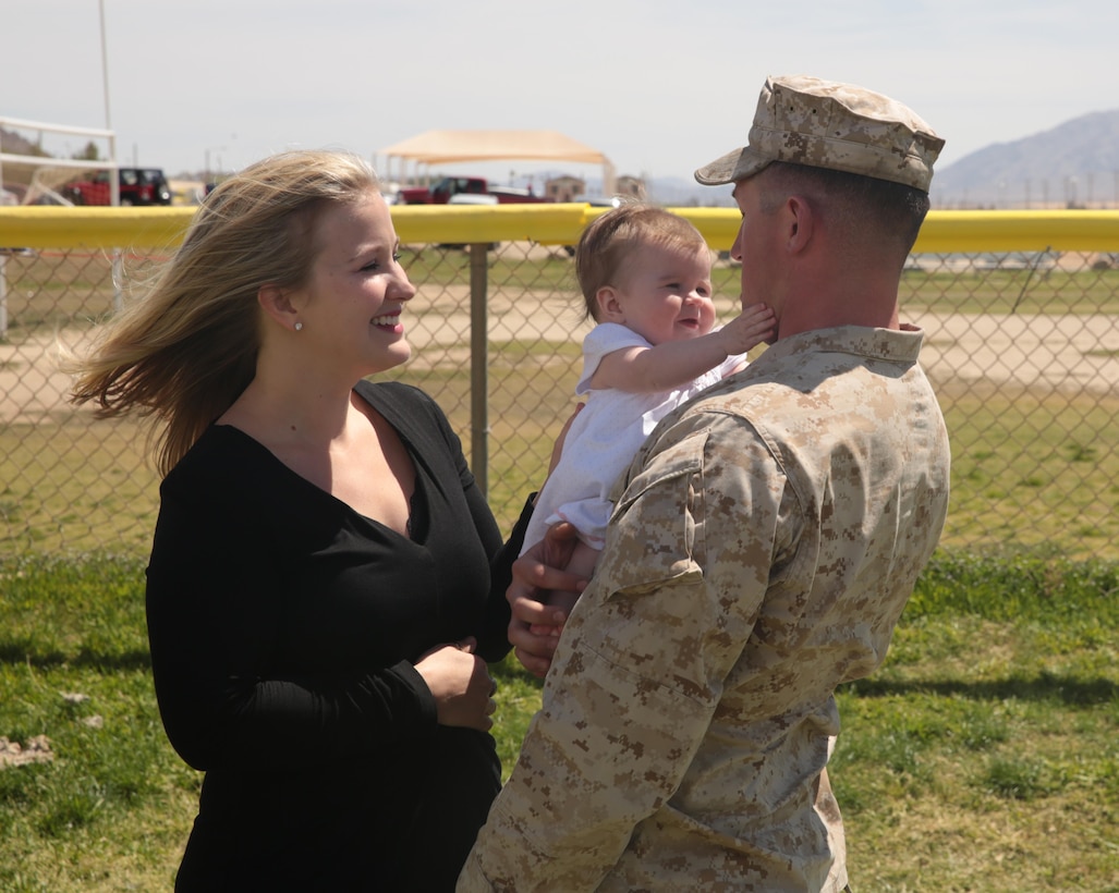 1st Lt. Christopher Solop, platoon commander, 2nd Battalion, 7th Marine Regiment, meets his 6-month-old daughter, Ava, for the first time during the battalion’s homecoming at Del Valle Field, April 6, 2015. Marines and sailors of 2/7 served as part of the Special Purpose Marine Air Ground Task Force-Crisis Response-Central Command 15.1. (Official Marine Corps photo by Lance Cpl. Medina Ayala-Lo/Released)