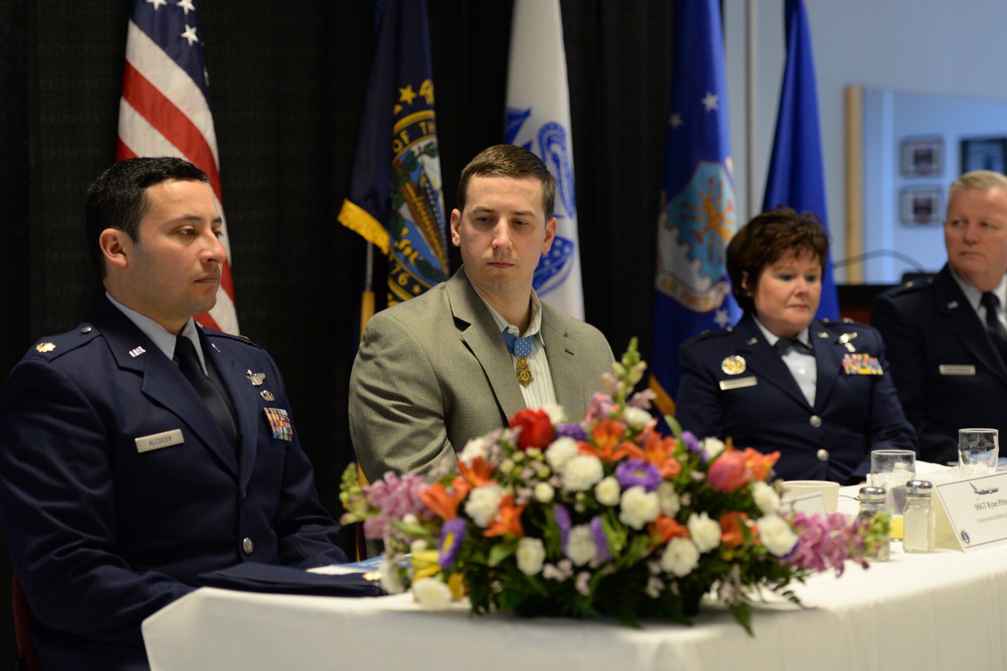 Former U.S. Army Staff Sgt. Ryan Pitts (center) listens during the Commander’s Annual Prayer Breakfast, Pease Air National Guard Base, N.H. April 12, 2015.  Pitts, a 2014 Medal of Honor recipient was guest speaker at the event. (U.S. Air National Guard photo by Staff Sgt. Curtis J. Lenz)