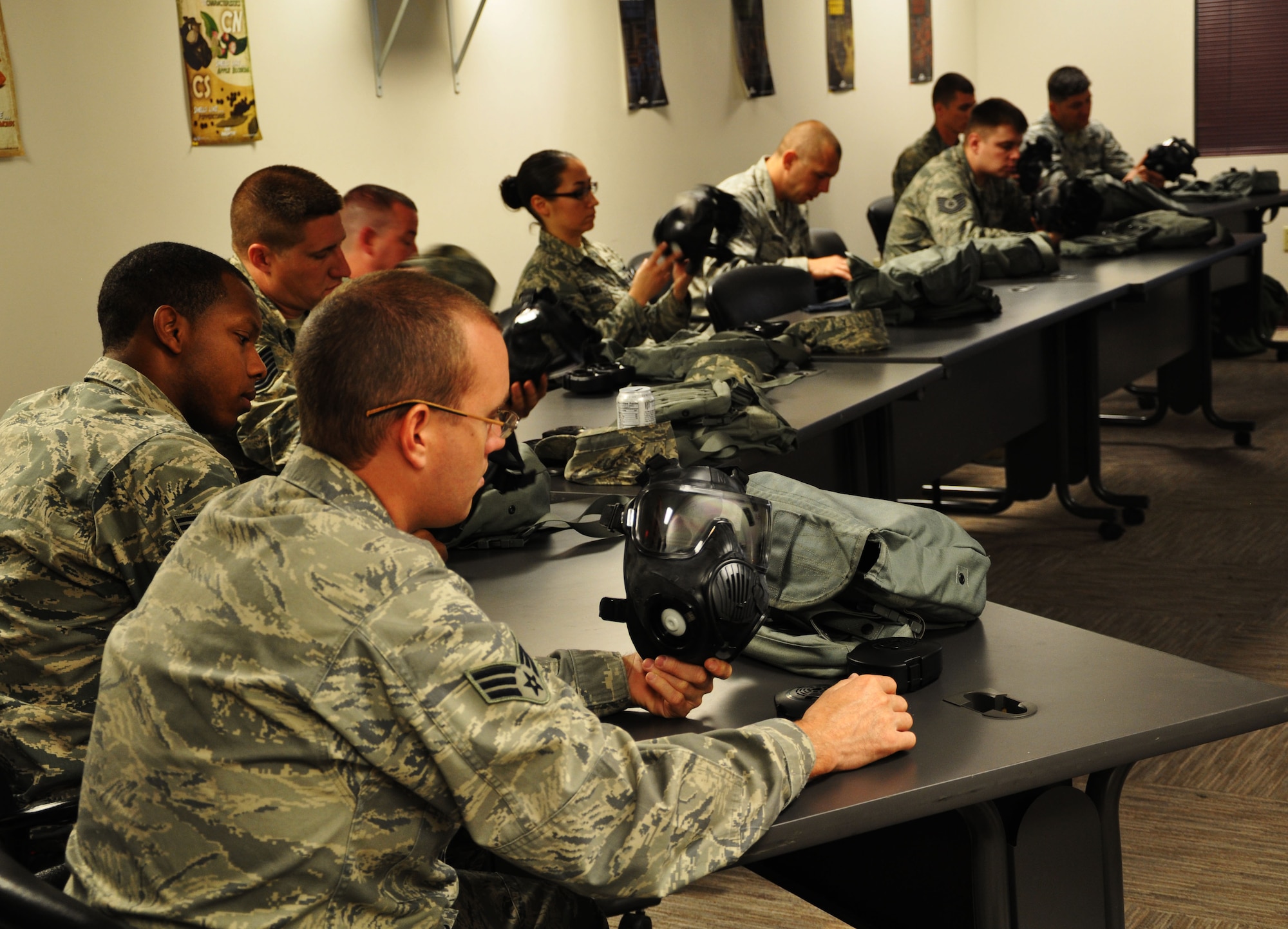 Members of the 931st Air Refueling Group inspect their gas masks for any holes or tears during a Chemical, Biological, Radiological, Nuclear and Explosive (CBRNE) training April 12, 2015, McConnell Air Force Base, The class ensures Airmen can work and survive in a chemical environment and that they are also prepared to handle any hazardous materials. (U.S. Air Force photo by Tech. Sgt. Abigail Klein)
