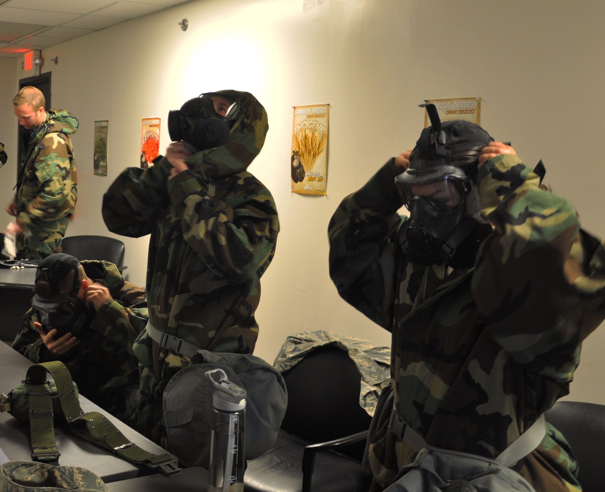 Members of the 931st Air Refueling Group don their mission oriented protective postures gear (MOPP) during a CBRNE training session April 12, 2015, McConnell Air Force Base, The class ensures Airmen can work and survive in a chemical environment and that they are also prepared to handle any hazardous materials. (U.S. Air Force photo by Tech. Sgt. Abigail Klein)