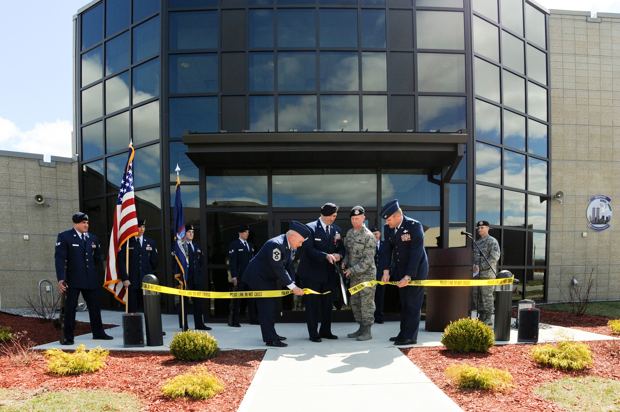 U.S. Air Force Master Sgt. Todd Lobraico, and Airman 1st Clas, James Byrne, the oldest and newest members of the 105th Base Defense Squadron, New York Air National Guard, cut the ribbon to officially open the 105 BDS Headquarters building with the assistance of Col Timothy J. LaBarge, commander of the 105th Airlift Wing, and Wing Command Chief Master Sgt. Joseph Rizzo . The opening was held shortly after the posthumous award of the Bronze Star Medal with Valor to SSgt. Todd "T.J." Lobraico on April 11, 2015. Lobraico Jr., a member of the 105th Airlift Wing, was killed in action in Afghanistan on Sept. 5, 2013, (U.S. Air National Guard photo by SSgt Michael OHalloran/Released) 