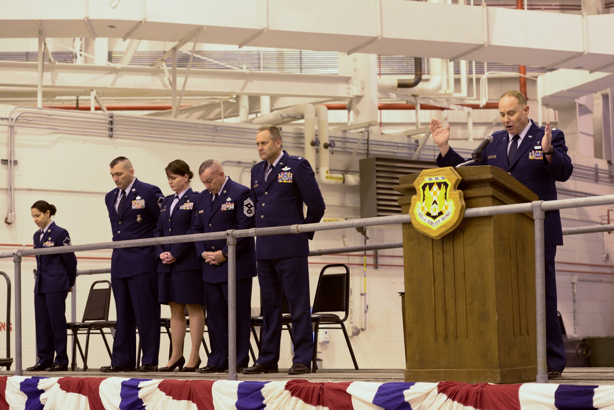105th Airlift Wing Chaplain, Lt Col Robert Tilli gives the opening prayer at a ceremony recognizing New York Air National Guard Staff Sgt. Todd "T.J." Lobraico, a member of the 105AW who was killed in action in Afghanistan in Sept. 5, 2013. Lt Col Linda Rohatsch and Master Sgt. Todd Lobriaco, "T.J."s parents both ot whom are members of the 105AW, accepted the posthumous award of the Bronze Star Medal with Valor, on his behalf at a ceremony presided over by Col Timothy J. LaBarge, commander 105AW at Stewart Air National Guard Base on Saturday, April 11, 2015.(U.S. Air National Guard Photo by SSgt Michael OHalloran/Released)