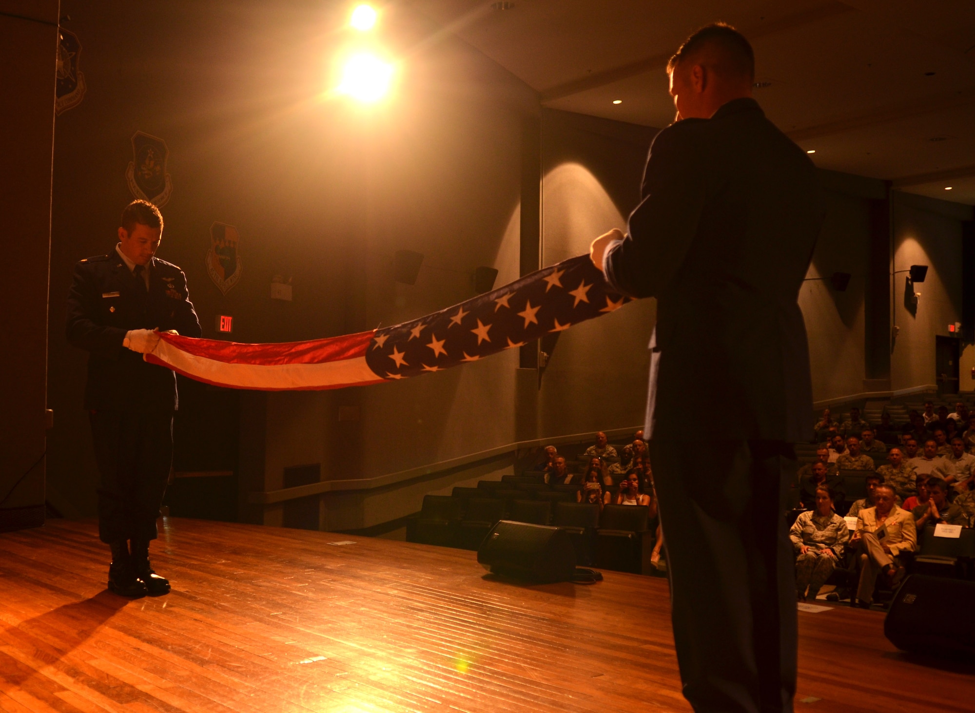 Maj. Jim Sluder (left) and Maj. Gabriel Hensley, combat rescue officers, 308th Rescue Squadron, conduct the flag-folding service during the Chief Master Sgt. Doug Kestranek’s retirement ceremony April 11, 2015. (U.S. Air Force photo/Senior Airman Natasha Dowridge)