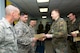 Lt. Col. Sven Henniger, commanding officer of movement and transport for the German Armed Forces Command Traffic and Transportation Division based out of Dulles International Airport, presents Staff Sgt. Jordan Soltis with the Schützenschnur, a German Armed Forces Badge for weapons proficiency. (Air National Guard photo by Master Sgt. Emily Beightol-Deyerle)