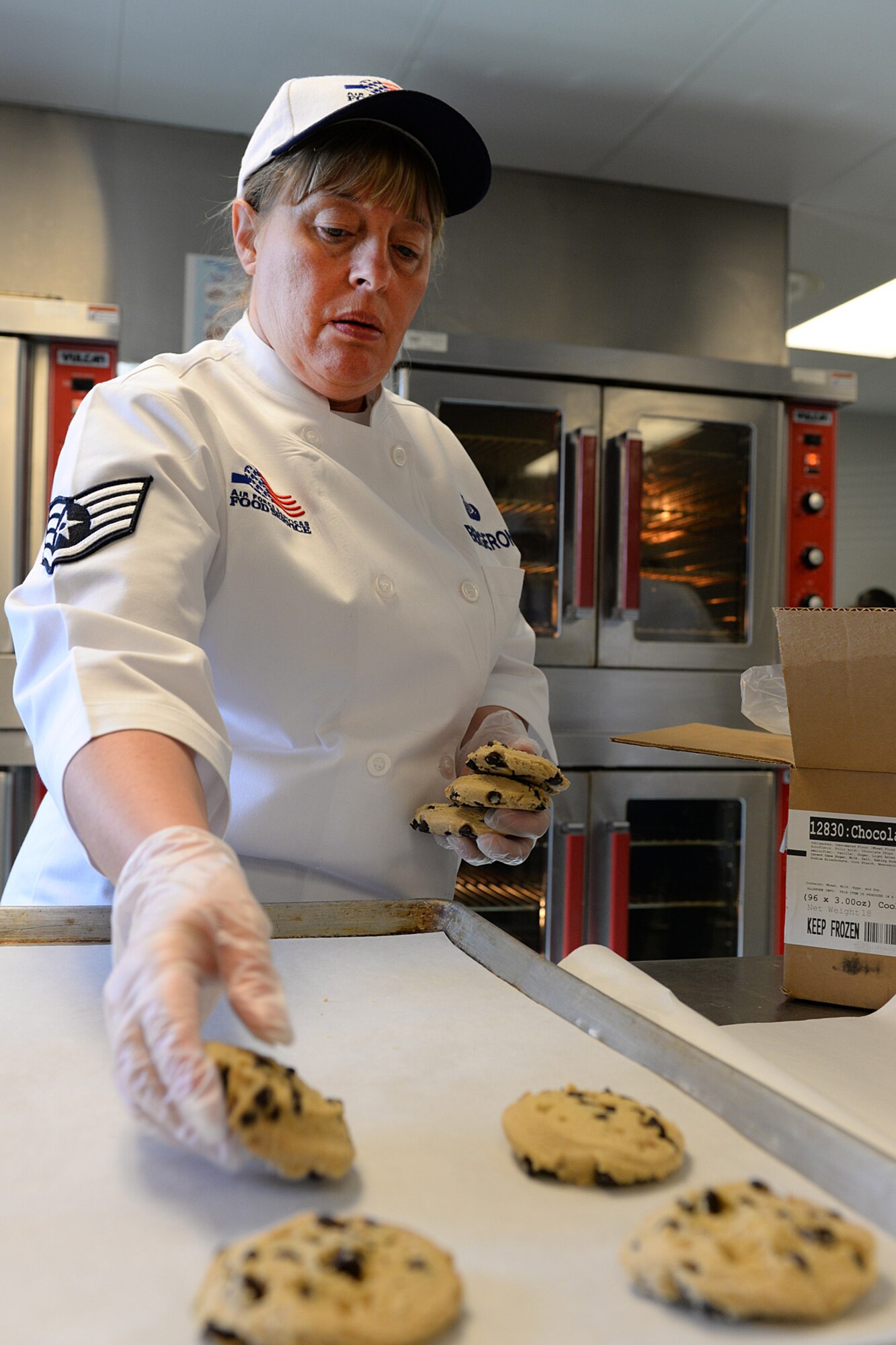 Staff Sgt. Jacqueline Bergeron, 157th Force Support Squadron Services Flight technician, places cookies on a cooking sheet during the April Unit Training Assembly in the kitchen of the Aerospace Dining Facility April 11. The 157 FSS team has been selected as one of the top three Air National Guard food services operations in the nation. Entering its 15th year, the Senior Master Sergeant Kenneth  Disney Award has been established to improve food service throughout the Air National Guard, increase morale, encourage competition, recognize excellence and honor the late Disney. Disney was the services superintendent at McGee Tyson Air Base, Tenn., for more than 20-years where he earned a reputation for commitment to providing outstanding food service. (N.H. Air National Guard photo by Senior Airman Kayla McWalter)