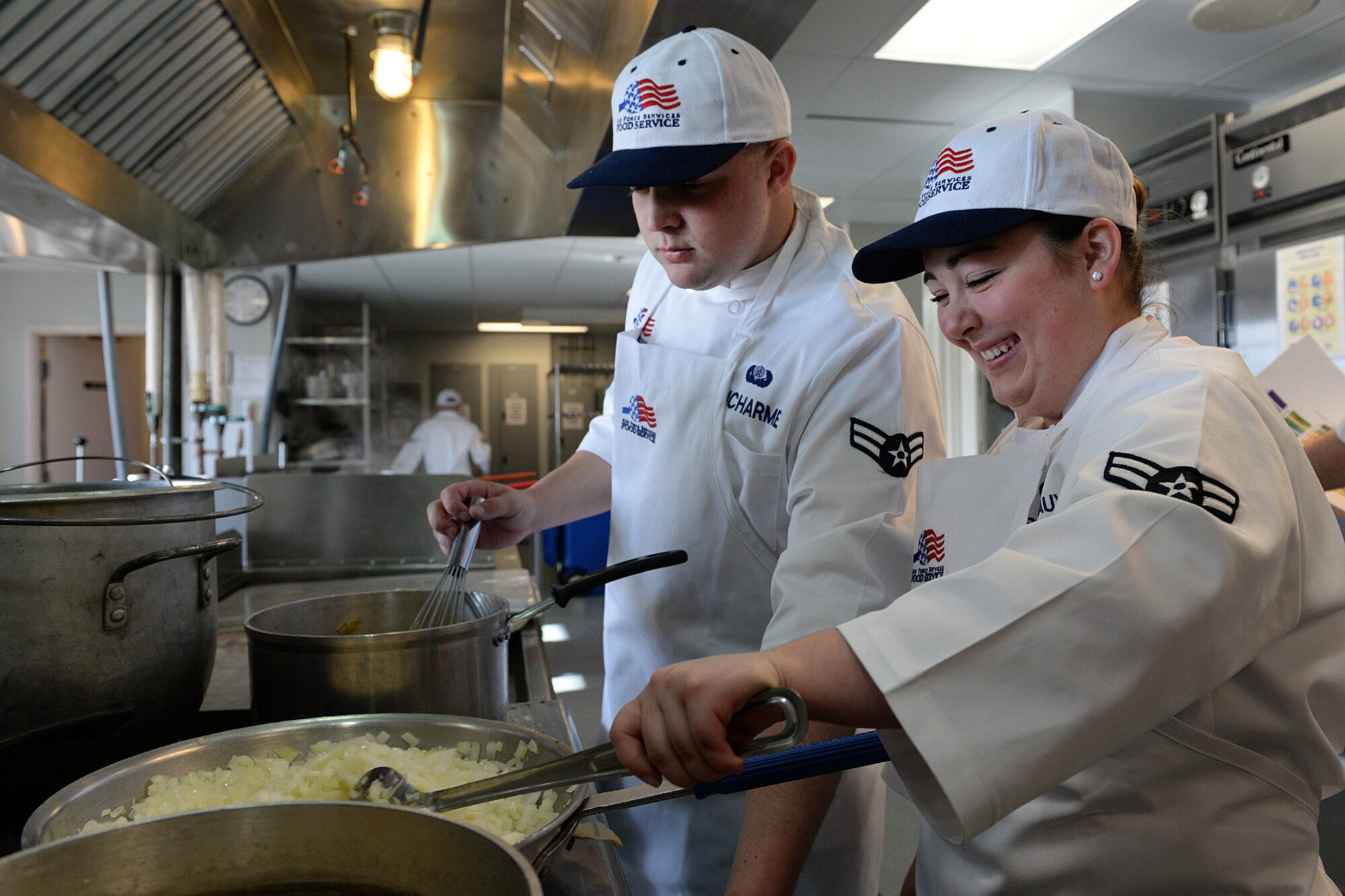 Airman 1st Class Ryan Ducharme and Airman 1st Class Jordyn Descoteaux, members of the 157th Force Support Squadron Services Flight, prepare lunch during the April Unit Training Assembly in the kitchen of the Aerospace Dining Facility April 11. The 157 FSS team has been selected as one of the top three Air National Guard food services operations in the nation. Entering its 15th year, the Senior Master Sergeant Kenneth  Disney Award has been established to improve food service throughout the Air National Guard, increase morale, encourage competition, recognize excellence and honor the late Disney. Disney was the services superintendent at McGee Tyson Air Base, Tenn., for more than 20-years where he earned a reputation for commitment to providing outstanding food service. (N.H. Air National Guard photo by Senior Airman Kayla McWalter)