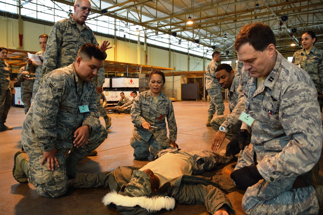 Maj. Andrew J. Rolniak III (left), a 433rd Medical Squadron clinical nurse, leads A1C Joshua Torres(kneeling), a medic, and Capt. Mark H. Stivers, a nurse, in treating a wounded  suspect during an active shooter exercise at the Kelly Field Annex at Port San Antonio- San Antonio, Texas on April 11, 2015.  (U.S. Air Force photo by Tech Sgt. Carlos J. Trevino)