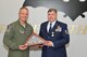 185th Air Refueling Wing Commander Col. Larry Christensen presents Tech. Sgt. Paul L. Logsdon with a U.S. flag on the occasion of his retirement on April 11, 2015 in Sioux City, Iowa. Logsdon, a long time unit member, retired from the 185th after more than 20 years of service with the Air Force and the Air National Guard. U.S. Air National Guard Photo by Tech. Sgt. Oscar Sanchez 185th ARW Wing Public Affairs/Released