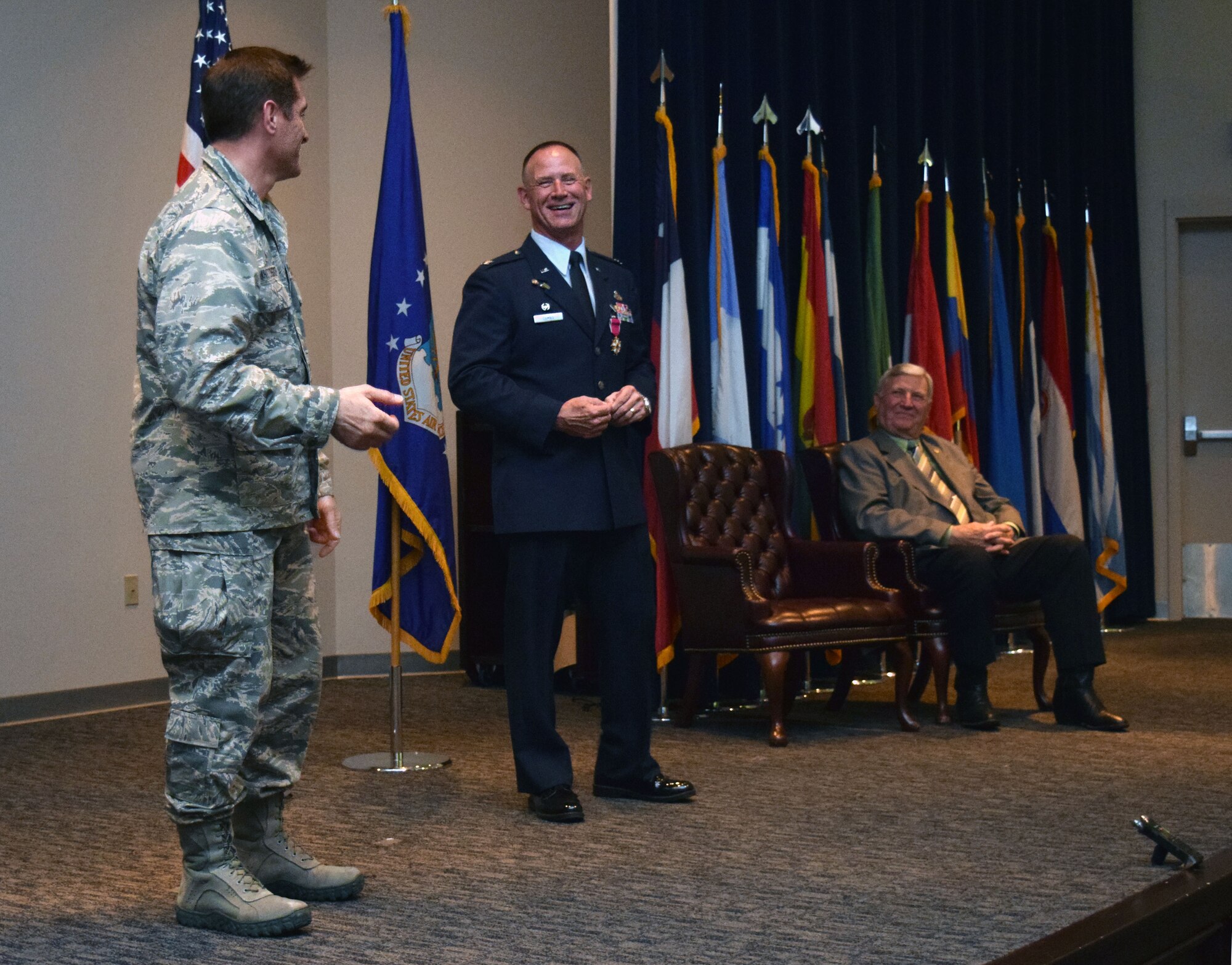 Col. William W. Whittenberger Jr., (left) 433rd Airlift Wing commander, honors Col. Charles M. Combs, 433rd Maintenance Group commander, during the group commander’s retirement ceremony April 11, 2015 at the Inter-American Air Force Academy, Joint Base San Antonio-Lackland, Texas. Colonel Combs, a New Mexico native, attended Officer Training School in August 1983, where he was commissioned as a second lieutenant. His Air Force career spanned more than 30 years. (U.S. Air Force photo/Tech. Sgt. Lindsey)
