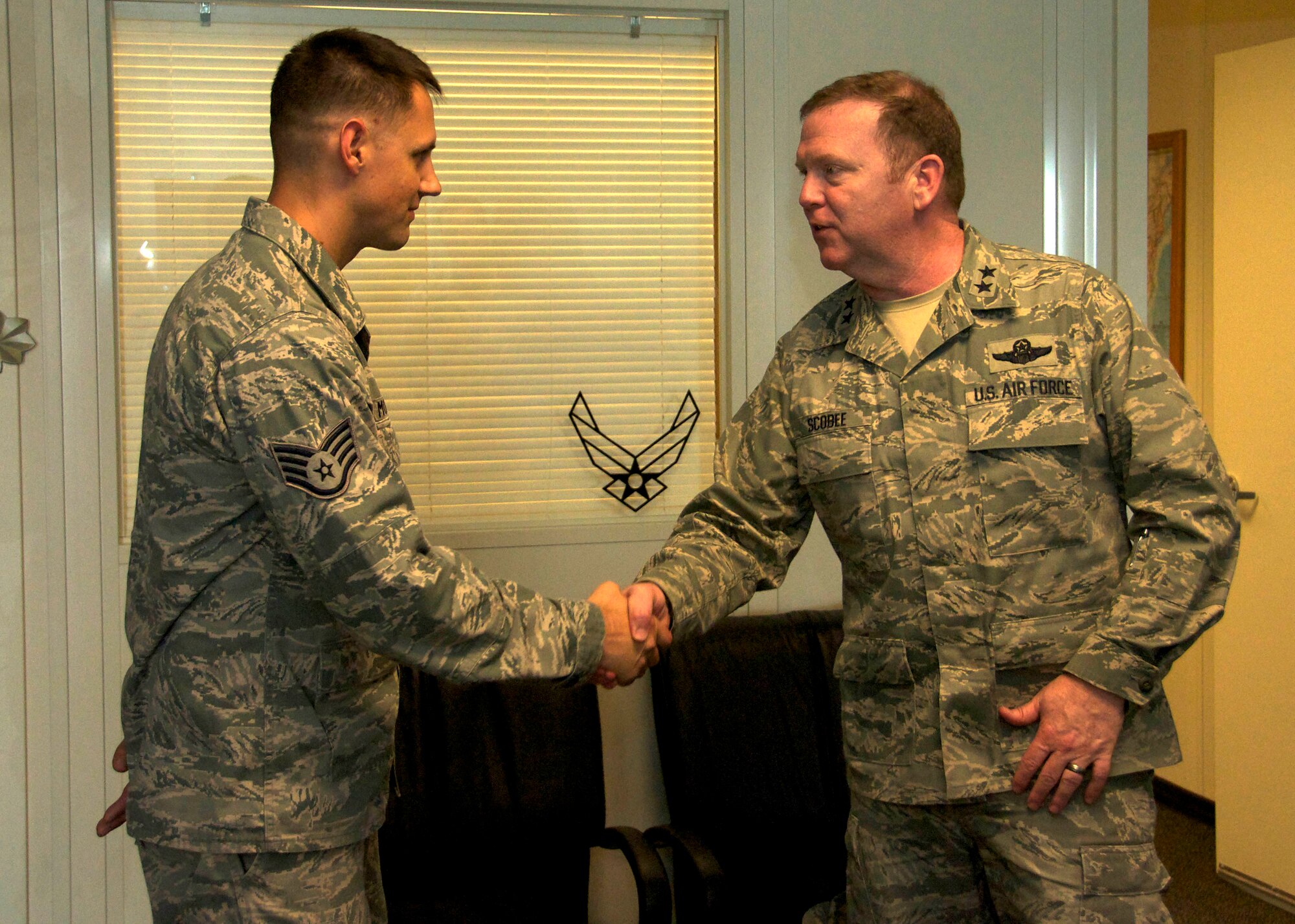 Major General Richard Scobee coined Staff Sgt. Timothy Morrison for being the noncommissioned officer of the quarter. 
“It was an honor to meet him,” said Morrison. “I actually did a report on the challenger spacecraft, which his father piloted years ago, so it was cool to be coined by him.”
(U.S. Air Force photo/Staff Sgt. Crystal Charriere)

