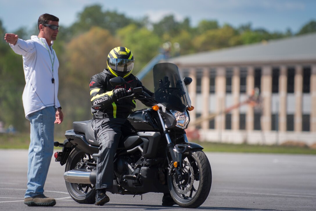 Master Sgt. Michael Biseinere, 919th Special Operations Wing, directs the rider to the next station during the motorcycle training course April 1 at Duke Field, Fla.  Members of the 919th SOW and the 7th Special Forces Group completed the Special Operations Command safety-hosted rider coach preparatory course to become state endorsed safety course instructors.  (U.S. Air Force photo/Tech. Sgt. Jasmin Taylor)
