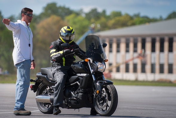 Master Sgt. Michael Biseinere, 919th Special Operations Wing, directs the rider to the next station during the motorcycle training course April 1 at Duke Field, Fla.  Members of the 919th SOW and the 7th Special Forces Group completed the Special Operations Command safety-hosted rider coach preparatory course to become state endorsed safety course instructors.  (U.S. Air Force photo/Tech. Sgt. Jasmin Taylor)