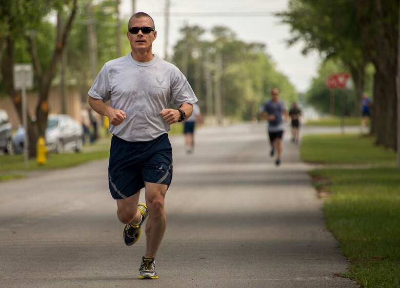 A participant races to the finish line during the spring 5k run and egg hunt April 11 at Duke Field, Fla. More than 50 people participated in the free event hosted by the Human Resource Development Council to boost base morale.  An Easter egg hunt followed the 5k at the playground with a bouncy house. (U.S. Air Force photo/Tech. Sgt. Cheryl Foster)