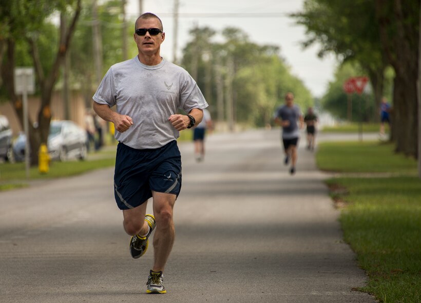 A participant races to the finish line during the spring 5k run and egg hunt April 11 at Duke Field, Fla. More than 50 people participated in the free event hosted by the Human Resource Development Council to boost base morale.  An Easter egg hunt followed the 5k at the playground with a bouncy house. (U.S. Air Force photo/Tech. Sgt. Cheryl Foster)