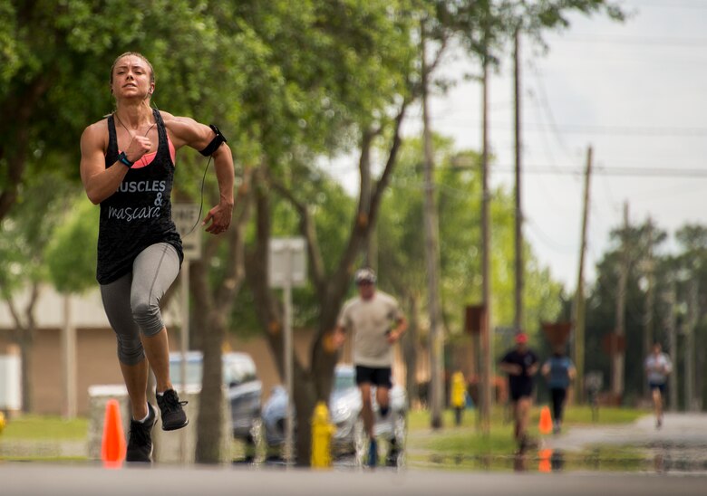 Master Sgt. Brianne Forrester, 919th Special Operations Force Support Squadron, sprints to the end of the spring 5k run and egg hunt April 11 at Duke Field, Fla. More than 50 people participated in the free event hosted by the Human Resource Development Council to boost base morale.  An Easter egg hunt followed the 5k at the playground with a bouncy house. (U.S. Air Force photo/Tech. Sgt. Cheryl Foster)