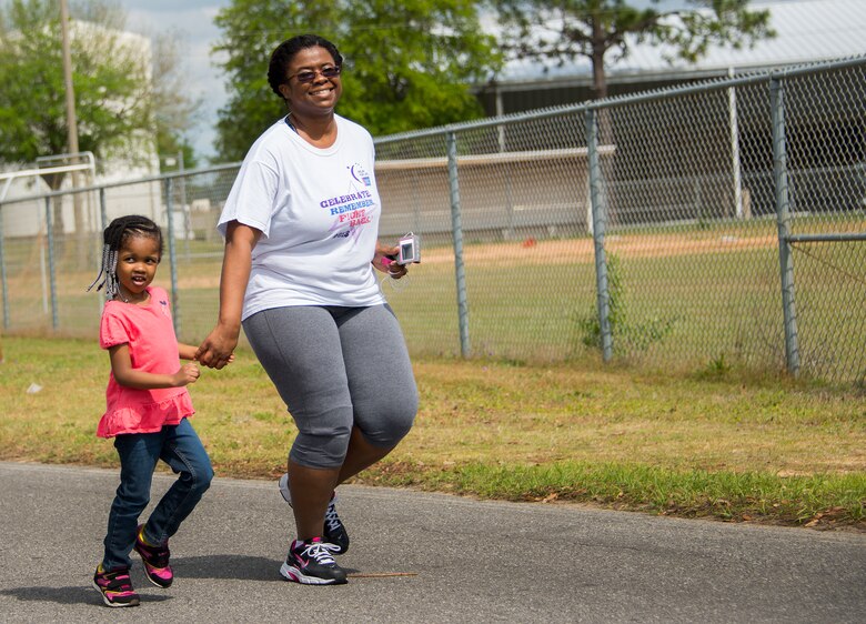Master Sgt. Tiffany Prophet, 919th Special Operations Wing, and her daughter, participate in the spring 5k run and egg hunt April 11 at Duke Field, Fla. More than 50 people participated in the free event hosted by the Human Resource Development Council to boost base morale.  An Easter egg hunt followed the 5k at the playground with a bouncy house. (U.S. Air Force photo/Tech. Sgt. Cheryl Foster)