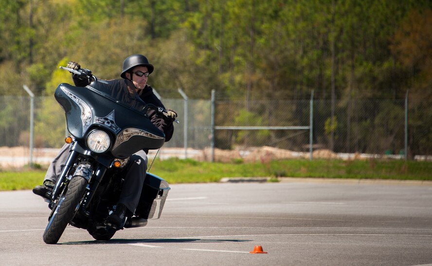 Tech. Sgt. Christian Lewis, 6th Special Operations Squadron, banks for a turn during the training course April 1 at Duke Field, Fla.  Members of the 919th Special Operations Wing and the 7th Special Forces Group completed the Special Operations Command safety-hosted rider coach preparatory course to become state endorsed safety course instructors.  (U.S. Air Force photo/Tech. Sgt. Jasmin Taylor)