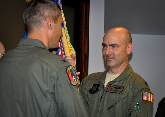 Lt. Col. Ray Roszkowski accepts the guidon from Col. Robert Bruckner, 919th Special Operations Wing vice commander, taking command of the 5th Special Operations Squadron during a ceremony at Hurlburt Field, Fla., April 11.  The 5th SOS provides instructors for the Air Force Special Operations Training Center's U-28 and Combat Aviation Advisor programs.  It also provides intratheater support to Special Operations Forces worldwide in support of National Command Authorities taskings.  (U.S. Air Force photo/Dan Neely)