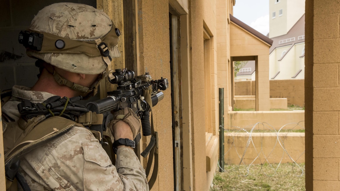 Corporal Jordan Collins, a squad leader with 2nd Combat Engineer Battalion, 2nd Marine Division, and New Orleans, Louisiana native, holds his position in the defense during Military Operations in Urban Terrain, or MOUT, training aboard Marine Corps Base Camp Lejeune, North Carolina, April 8, 2015. The training included Marines going out in squad-sized elements to attack an objective being held by opposing forces in the defensive position after the squad leaders built terrain models and informed their Marines on avenues of approach and tasks. (U.S. Marine Corps photo by Cpl. Krista James/Released)