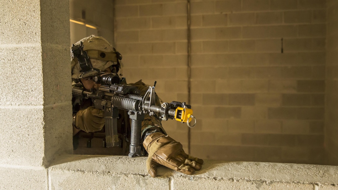 A Marine with 2nd Combat Engineer Battalion, 2nd Marine Division maintains cover fire for his fire team during Military Operations in Urban Terrain, or MOUT, training aboard Marine Corps Base Camp Lejeune, North Carolina, April 8, 2015. “The main purpose of this training is to essentially sharpen our skills as squads, and to utilize the other portion of our [military occupational specialty] which is provisional infantry,” said Staff Sgt. Travis Payne, a platoon sergeant with 2nd CEB. “Being able to employ our engineers and to use our Marines in those tactics makes them much more of an asset to 2nd Marine Division.” (U.S. Marine Corps photo by Cpl. Krista James/Released) 