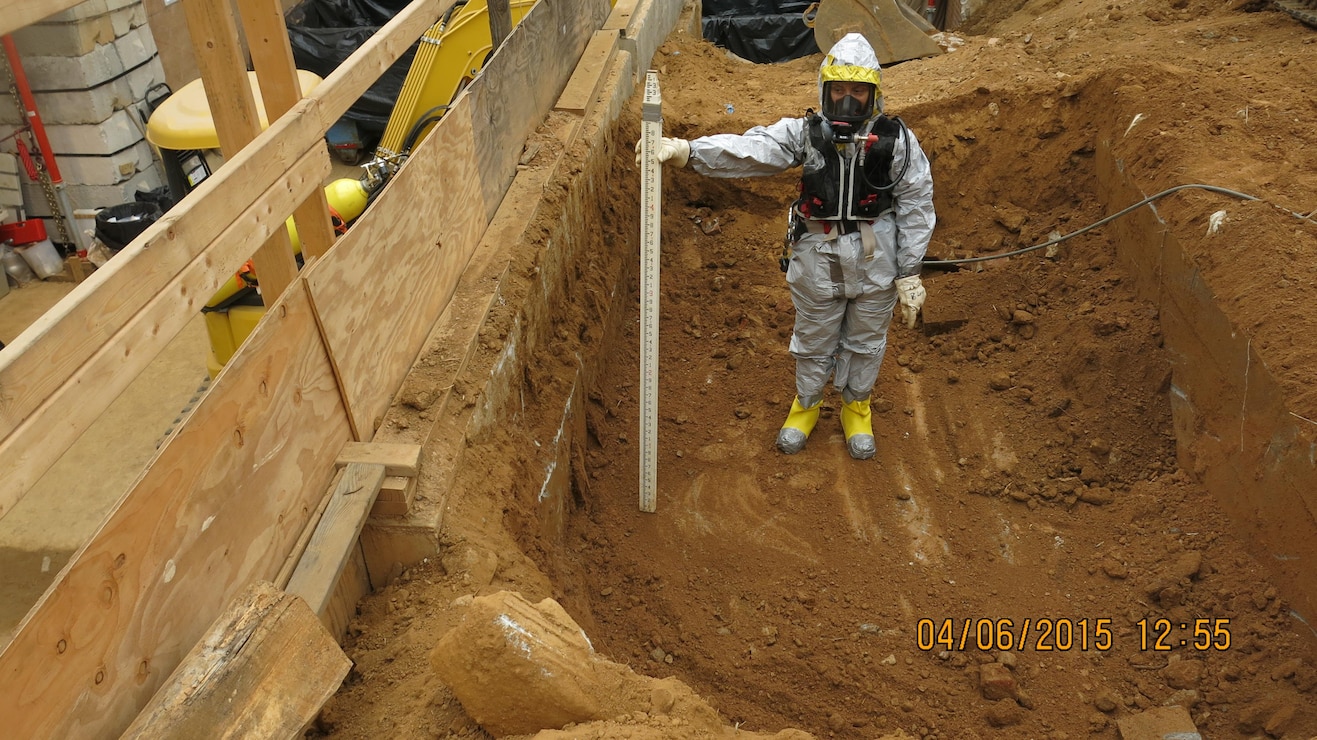 Crews measure the depth of the current excavation under the second tent location at 4825 Glenbrook Road.