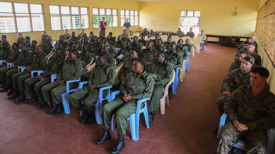 Marines and Sailors assigned to a Security Cooperation Team with Special-Purpose Marine Air-Ground Task Force Crisis Response-Africa, and Tanzanian park rangers attend a graduation ceremony on the Selous Game Reserve in Matambwe, Tanzania, March 27, 2015. More than 40 park rangers graduated from counter illicit-trafficking training, which was the first-ever engagement between U.S. Marines and Tanzanian park rangers. The Marines and Sailors taught the park rangers infantry skills such as weapons handling, land navigation, and patrolling in an attempt to help combat illicit-trafficking. 