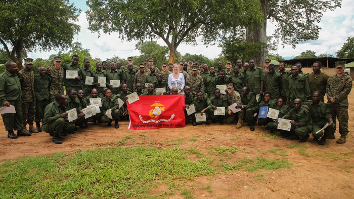 Virginia Blazer, center, the U.S. Deputy Chief of Mission to Tanzania, poses for a photo with Marines and Sailors assigned to a Security Cooperation Team with Special-Purpose Marine Air-Ground Task Force Crisis Response-Africa, and more than 40 Tanzanian park rangers following a graduation ceremony on the Selous Game Reserve in Matambwe, Tanzania, March 27, 2015. The park rangers graduated from counter illicit-trafficking training, which was the first-ever engagement between U.S. Service members and Tanzanian park rangers. The Marines and Sailors taught the park rangers infantry skills in an attempt to help counter illicit-trafficking in the region. 