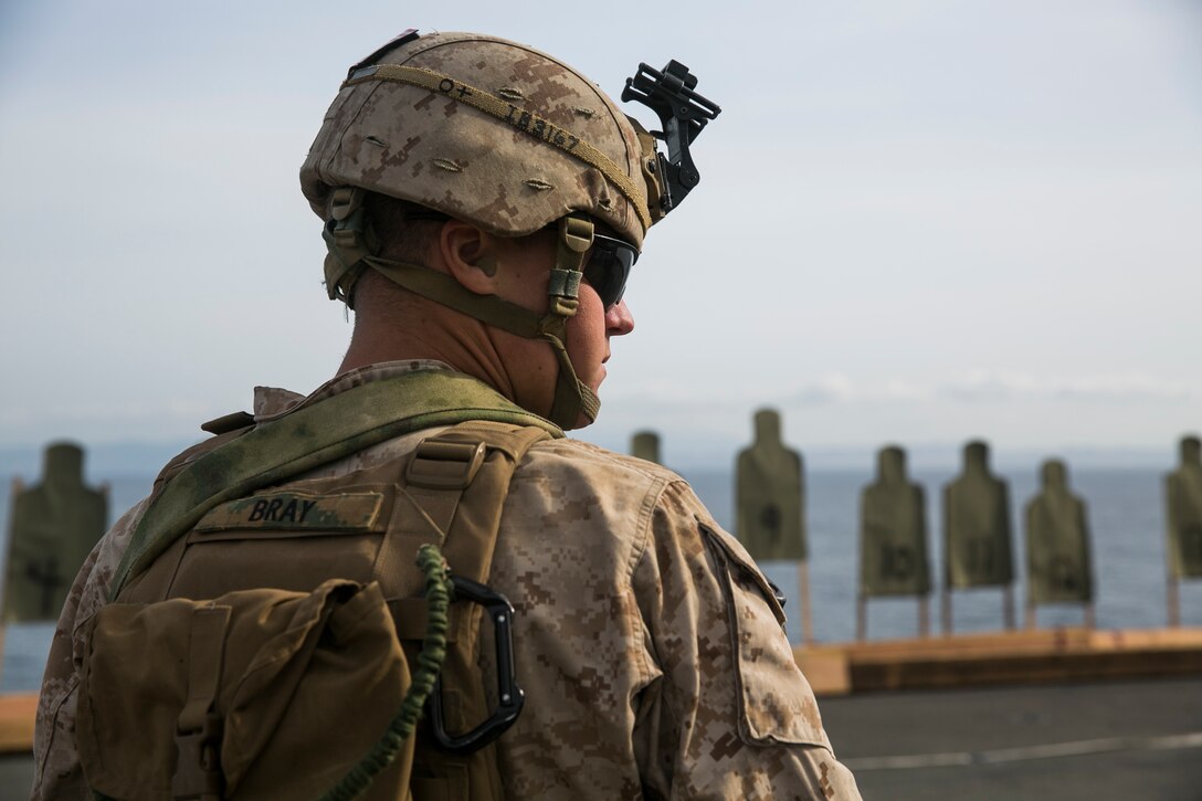U.S. Marine Lance Cpl. Caleb Bray participates in a deck shoot during Certification Exercise (CERTEX) aboard the USS Essex (LHD 2) off the coast of San Diego April 10, 2015. Bray is with the 15th Marine Expeditionary Unit’s Maritime Raid Force’s security element. These Marines use deck qualifications to enhance their marksmanship skills while at sea. (U.S. Marine Corps photo by Cpl. Anna Albrecht/Released)