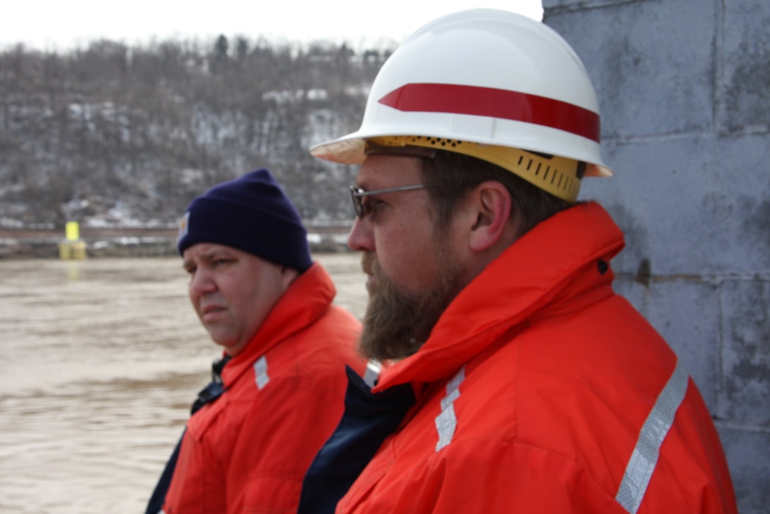 John Dilla, (right), chief, Locks and Dams Branch, and Mark Ivanisin, Ohio River operations supervisor, observe barge recovery operations. 