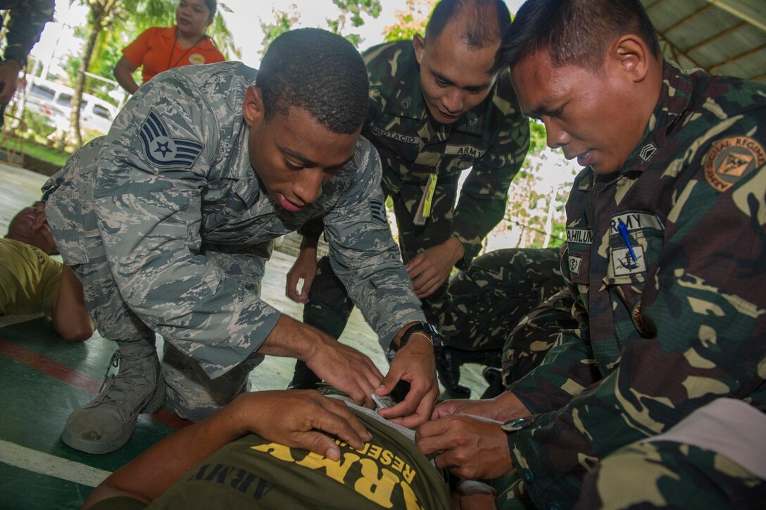 U.S. Air Force Staff Sgt. Justin Stinson, left, assigned to the 15th Medical Operations Squadron, along with Armed Forces of the Philippines Army Soldiers, attend to a casualty at a simulated mass casualty exercise in Jamindan, Philippines, during Balikatan 2015, April 9. The exercise was part of a cooperative health engagement, train-the-trainer first responder course at the headquarters of the AFP’s 3rd Infantry Division, which was attended by AFP Soldiers and civilian personnel from the Capiz Emergency Response Team. Balikatan, which means “shoulder to shoulder” in Filipino, is an annual bilateral training exercise aimed at improving the ability of Philippine and U.S. military forces to work together during planning, contingency, humanitarian assistance and disaster relief operations. 